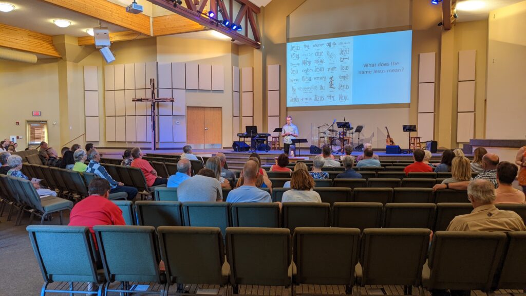 People gathered at Hope Community Covenant Church listening to a sermon.