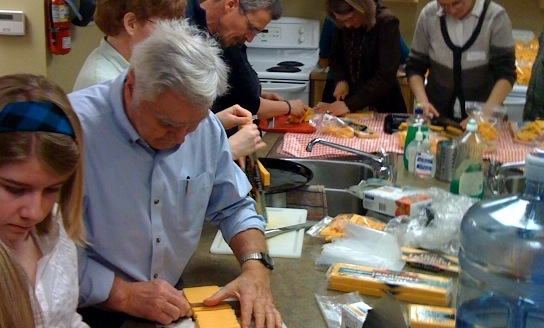 People gathered in the Hope Community Covenant Church kitchen preparing food.